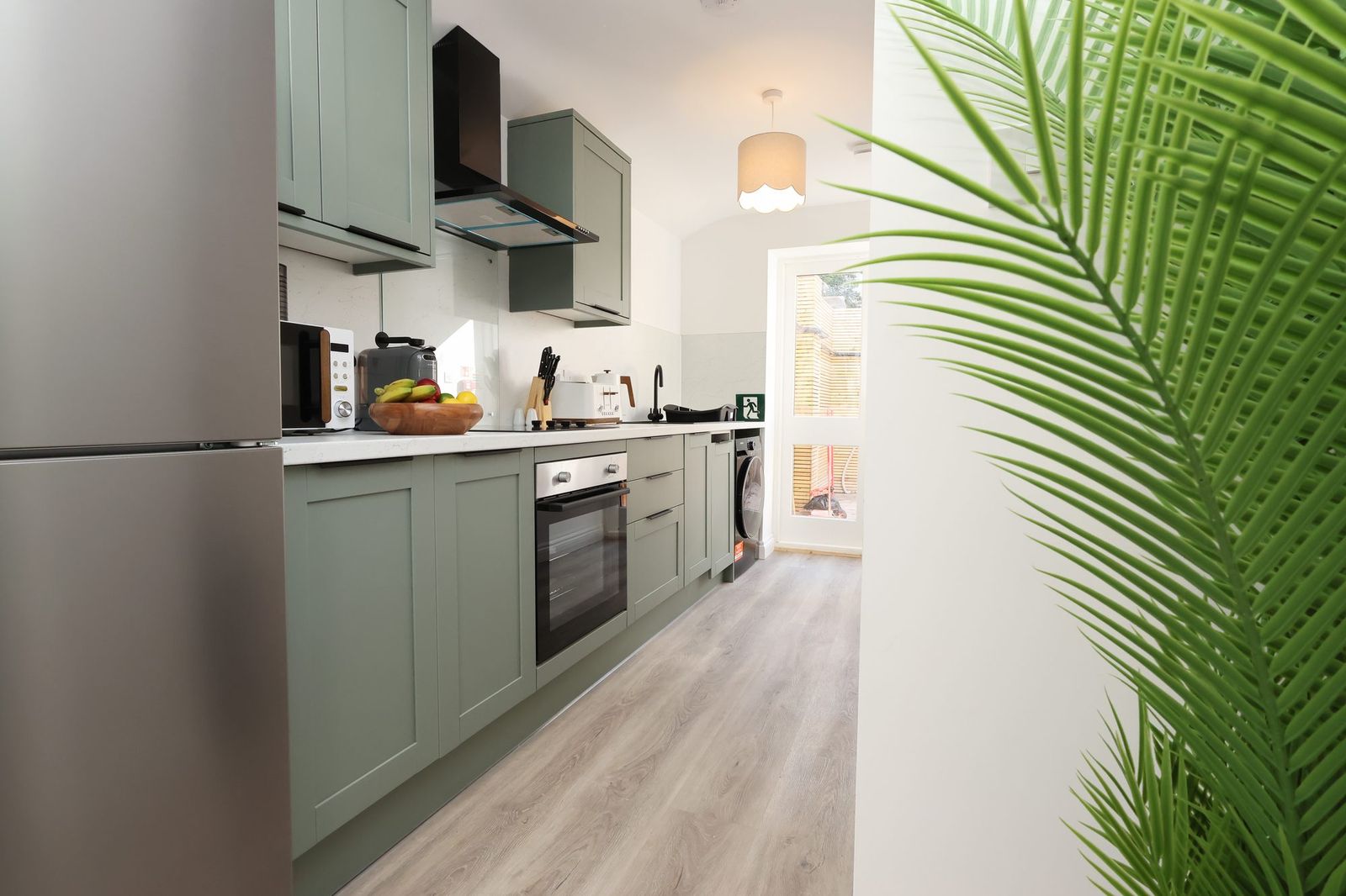 Kitchen, sage green units and quartz-effect worktops